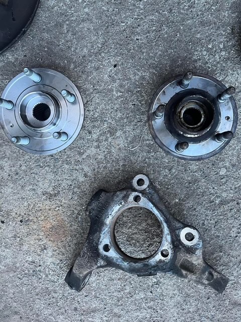 Wheel hubs and hub carrier laid out during a repair